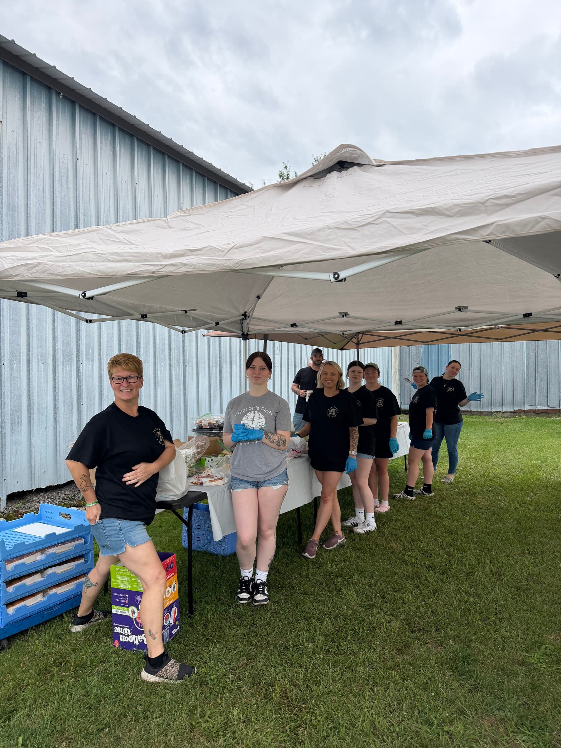 Volunteers lined up under the tent, ready to serve