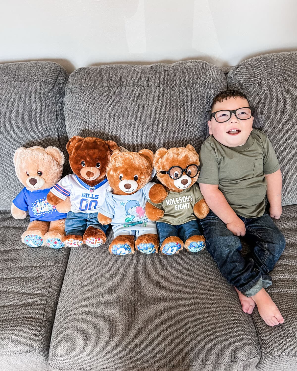 Koleson Meakin lying beside his four teddy bears